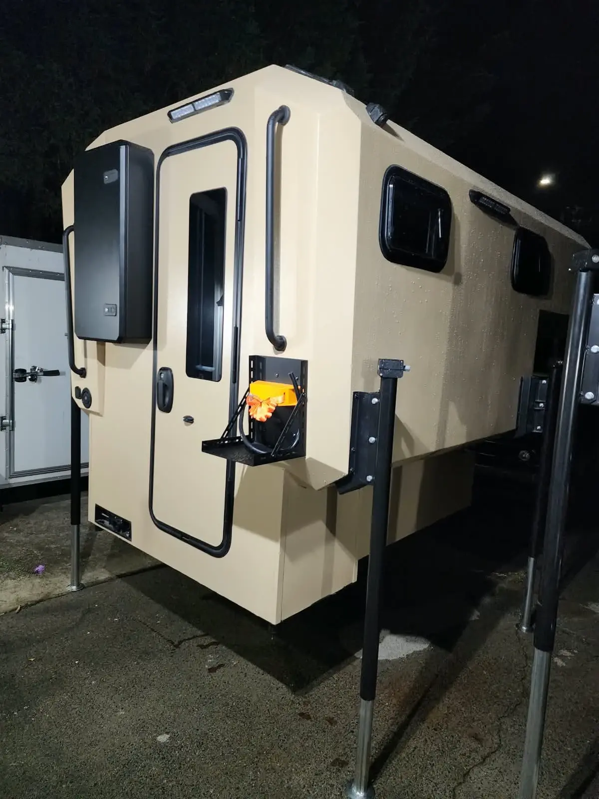 Camper 02 — Warm Ivory, rear three-quarter exterior view at night